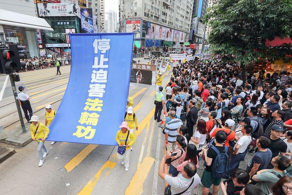 Na transparentu piše: „Zaustavite progon Falun Gonga" 