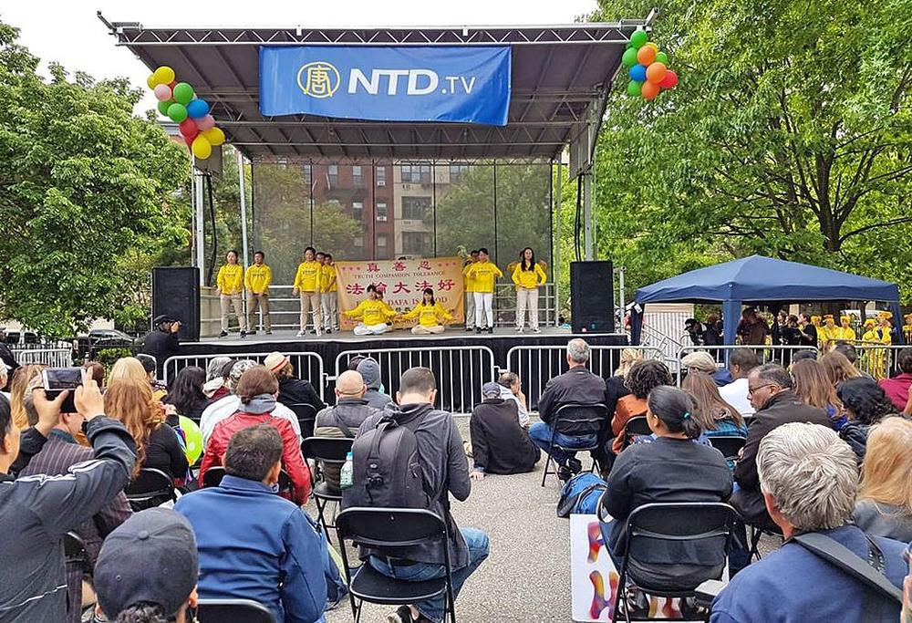 Praktikanti Falun Gonga govore o praksi i demonstriraju pet vježbi na pozornici u Tompkins Square parku. 