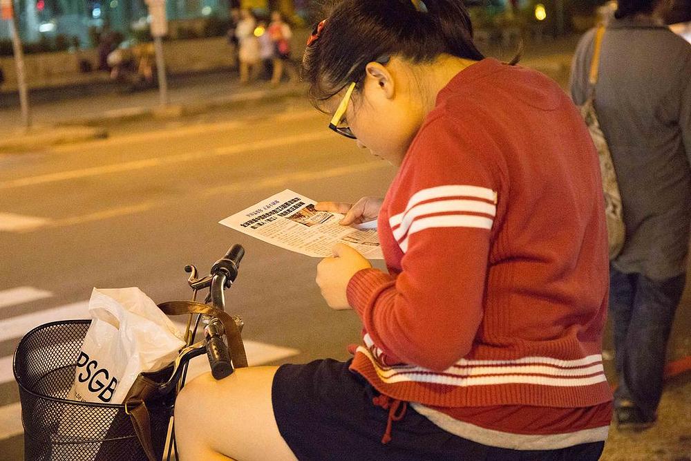 Djevojka pomno čita Falun Gong literaturu.